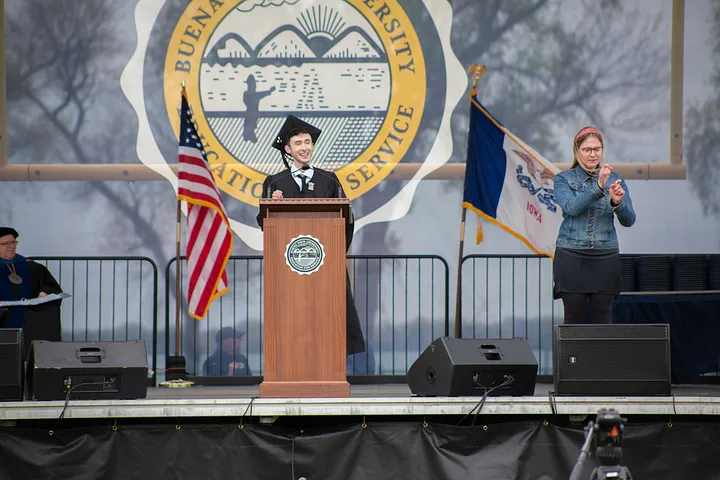 Ethan R. Ankrum (me) giving the student commencement speech at the 2021 Graduation on stage behind a podium